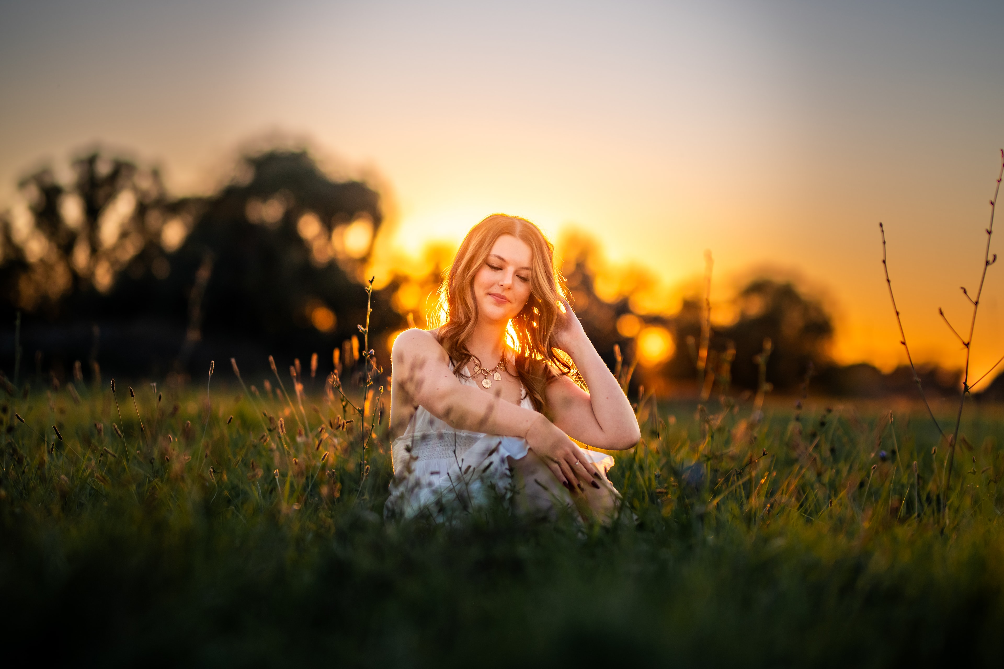 Woman with arms raised in sunset field — Treasure Valley horse photography session